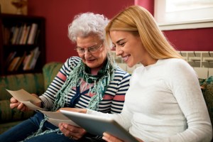 Old lady & daughter looking through photos