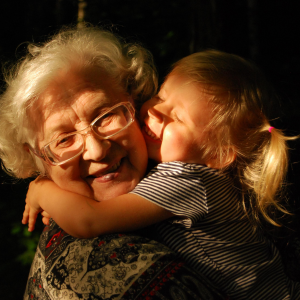 Child cuddling grandparent