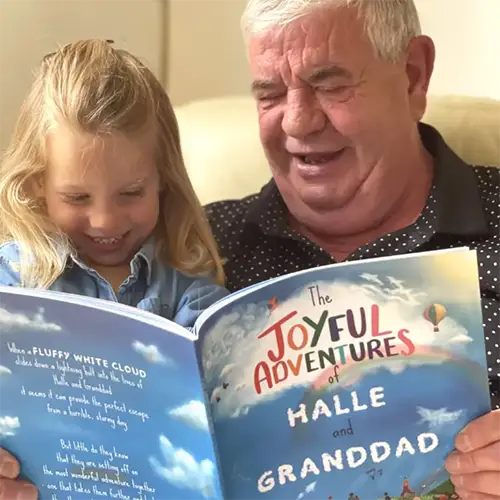 Grandad & granddaughter reading The Joyful Adventurtes by Tickled Moon