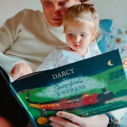 Mummy & child reading a bedtime personalised book by Tickled Moon