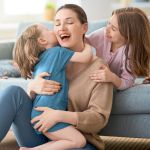 a mum being hugged by children on Mothers Day
